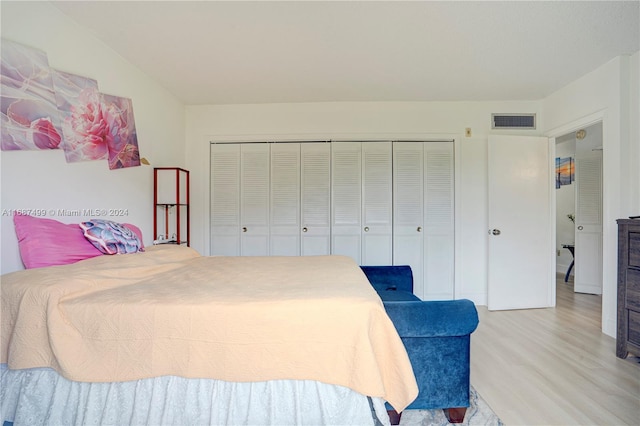 bedroom with a closet and light hardwood / wood-style flooring