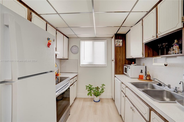 kitchen featuring white cabinets, white appliances, and light hardwood / wood-style flooring