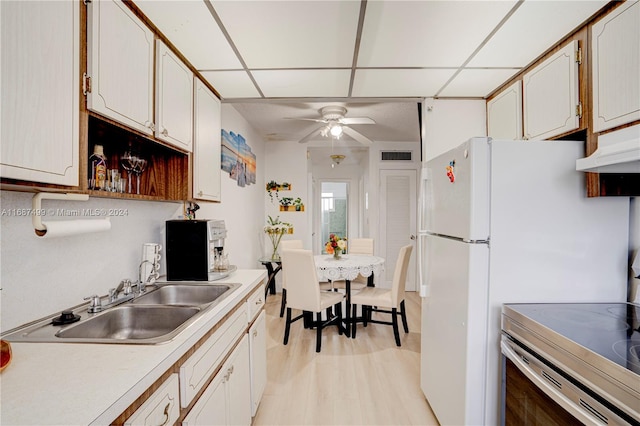 kitchen with white cabinets, ceiling fan, light hardwood / wood-style floors, and sink