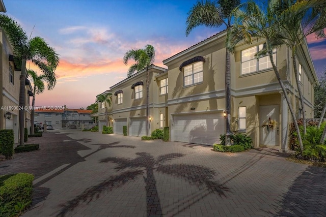 outdoor building at dusk featuring a garage