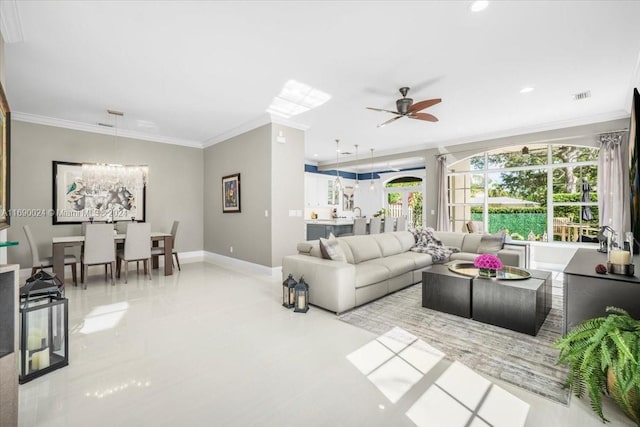 living room with ceiling fan with notable chandelier and ornamental molding