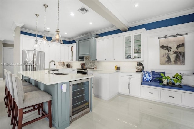 kitchen with decorative backsplash, a kitchen island with sink, beam ceiling, decorative light fixtures, and wine cooler