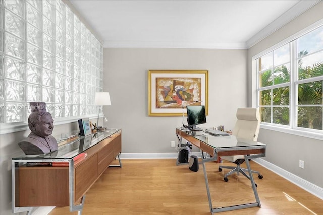 office space with crown molding and light wood-type flooring