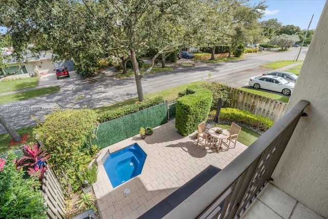 view of swimming pool featuring a patio area and a hot tub