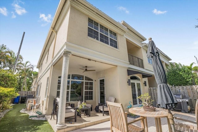 rear view of property featuring ceiling fan, a patio, and french doors