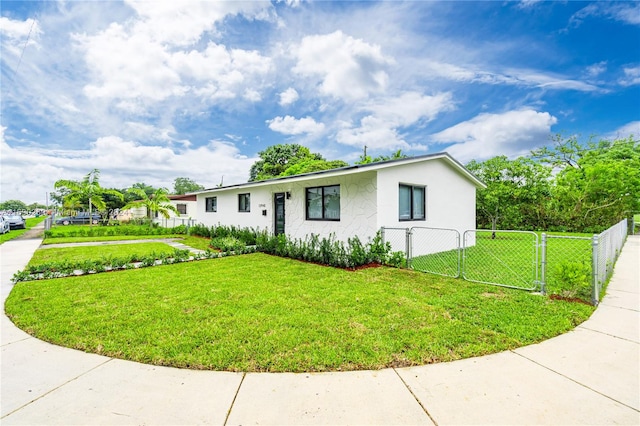 ranch-style house featuring a front lawn