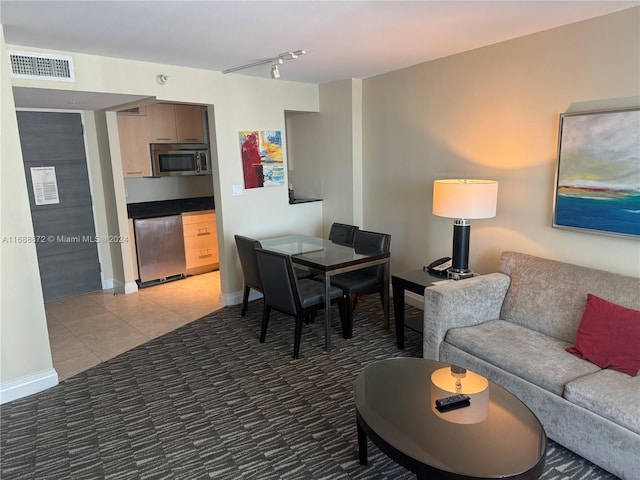 living room with light tile patterned flooring and rail lighting