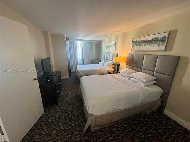 bedroom with dark colored carpet