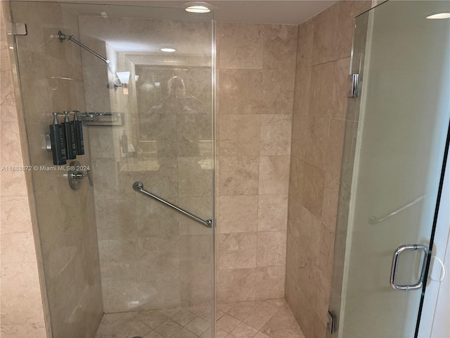 bathroom featuring a shower with shower door