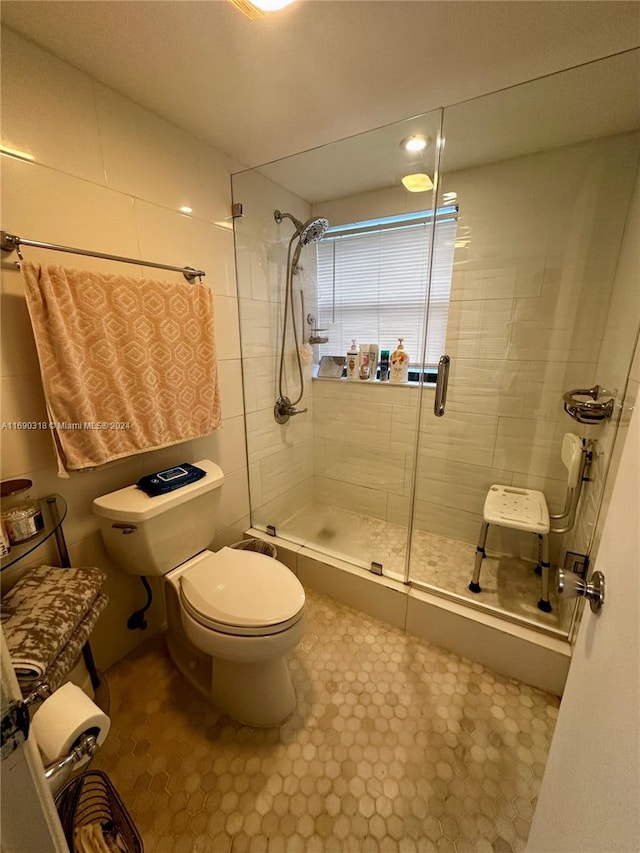 bathroom with toilet and an enclosed shower