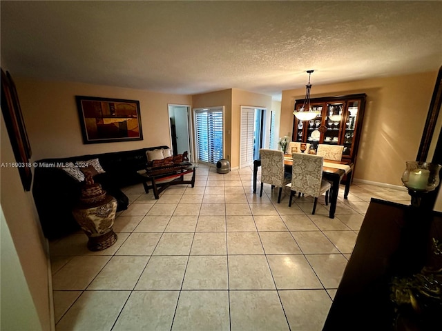 tiled dining area featuring a textured ceiling