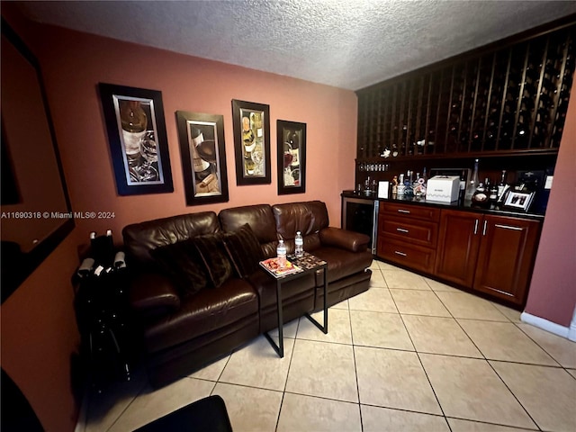 tiled living room with a textured ceiling and indoor bar