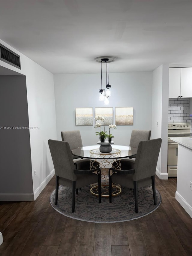 dining area with dark hardwood / wood-style floors