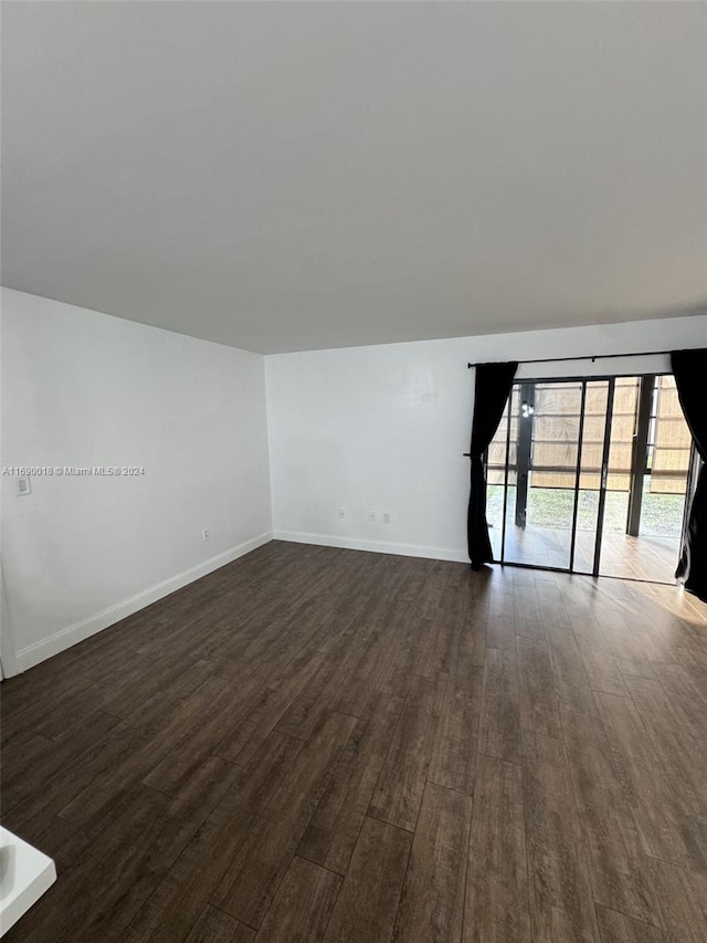 spare room featuring dark hardwood / wood-style flooring