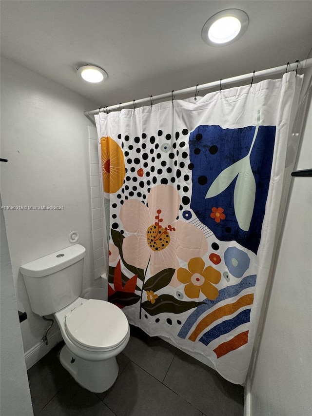 bathroom with tile patterned floors, toilet, and shower / bath combination with curtain