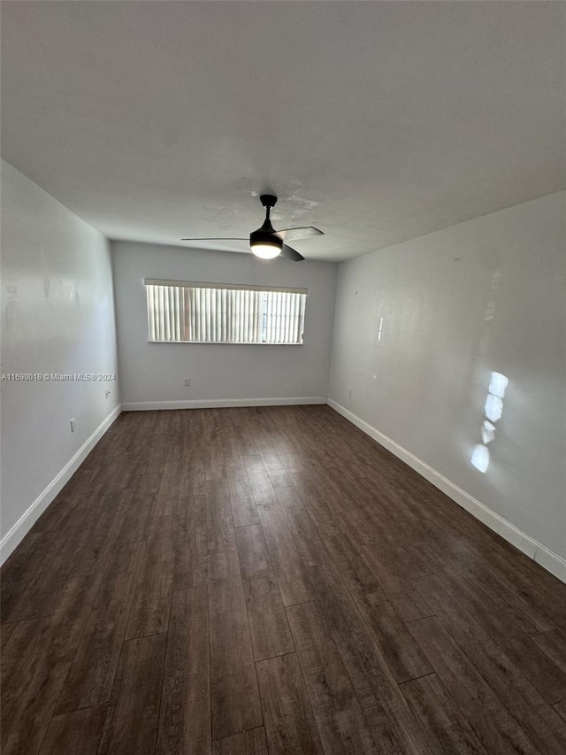 spare room with ceiling fan and dark hardwood / wood-style floors