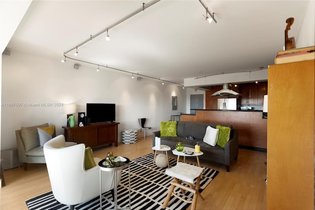 living room with rail lighting and light wood-type flooring