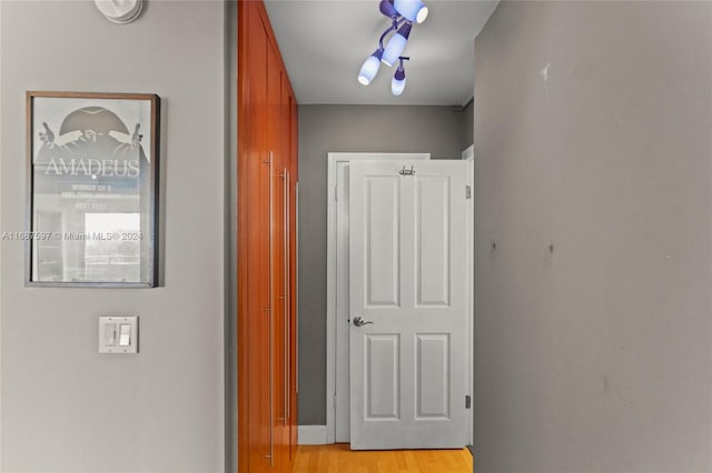 corridor with light hardwood / wood-style floors