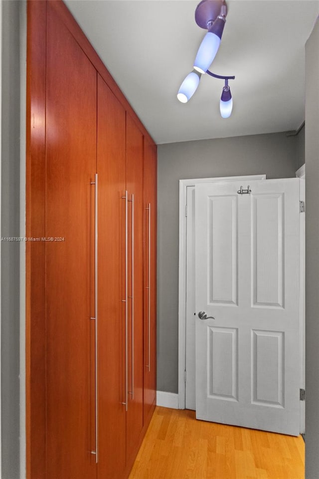 hallway with light hardwood / wood-style floors