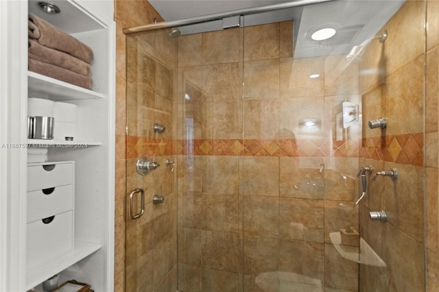 bathroom with a shower with door