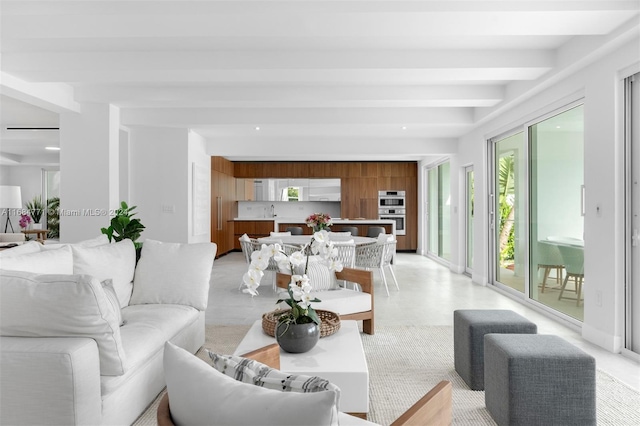 living room with sink and beamed ceiling