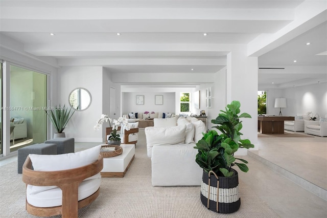 living room featuring light carpet and beamed ceiling