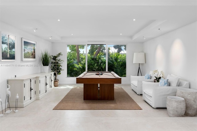 playroom with a raised ceiling and pool table