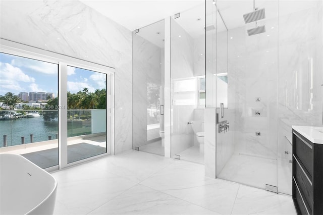 full bathroom featuring toilet, a water view, separate shower and tub, and tile walls