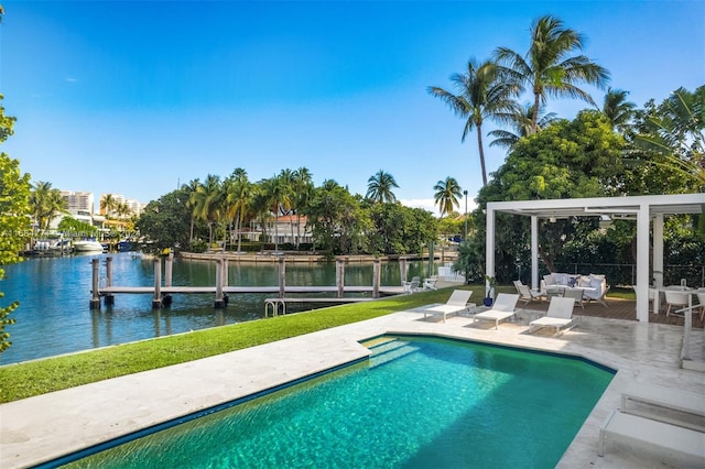 view of swimming pool featuring an outdoor living space, a water view, a patio, and a boat dock