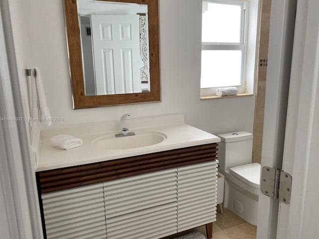 bathroom featuring toilet, vanity, and tile patterned flooring