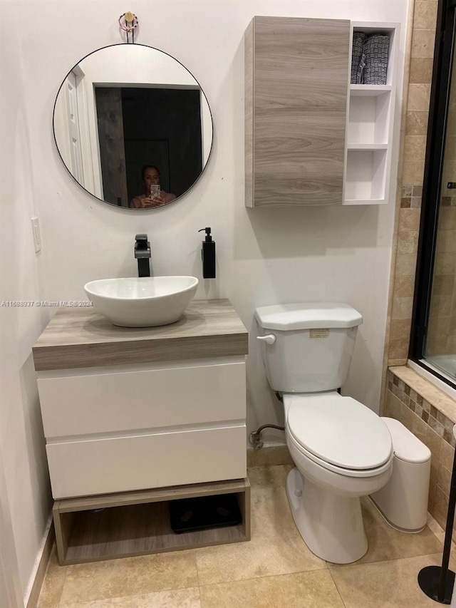 bathroom featuring toilet, vanity, and tile patterned floors