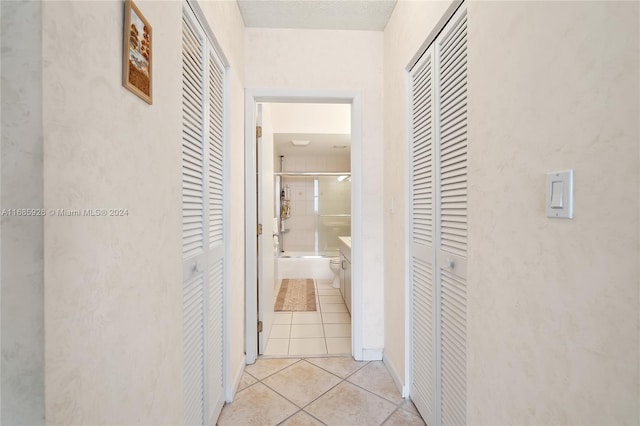 hall featuring light tile patterned floors