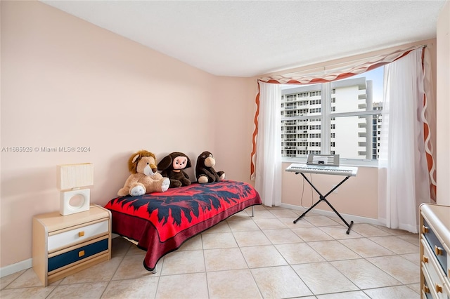 tiled bedroom featuring a textured ceiling