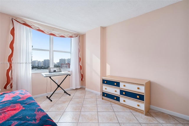 tiled bedroom with a textured ceiling