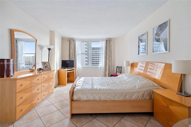 bedroom featuring a textured ceiling and light tile patterned floors