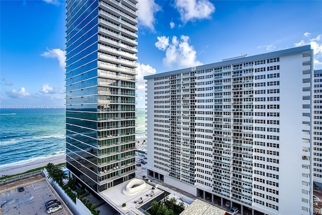 view of property featuring a beach view and a water view