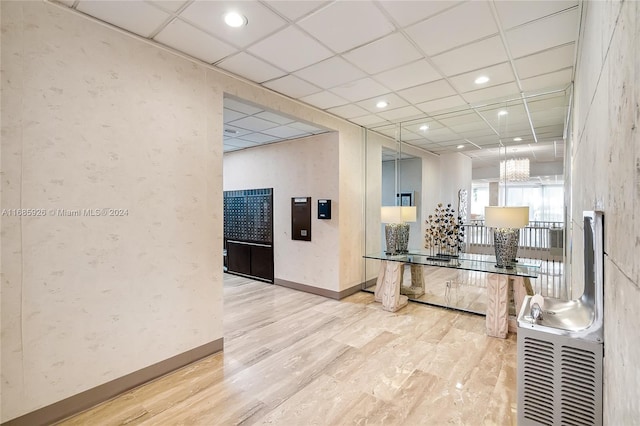 interior space featuring hardwood / wood-style floors and a paneled ceiling