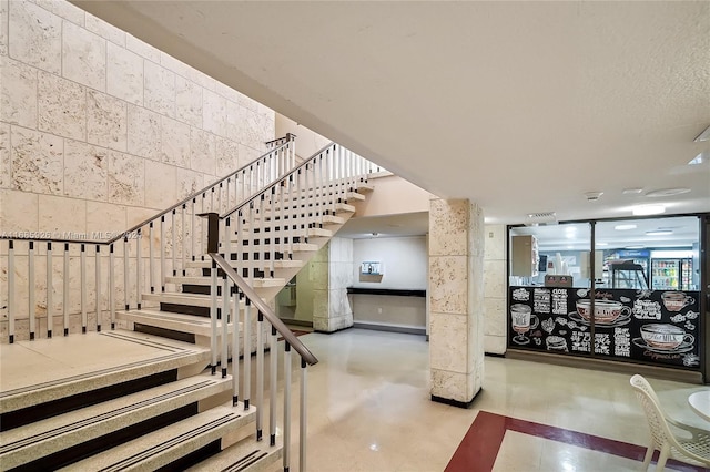 staircase with concrete flooring