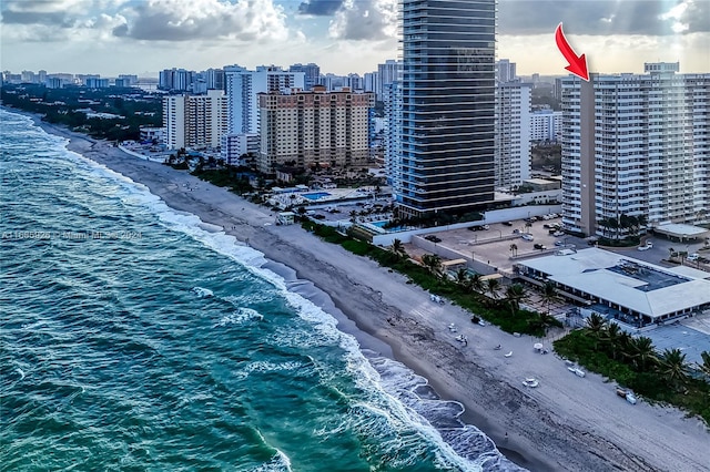 birds eye view of property featuring a view of the beach and a water view