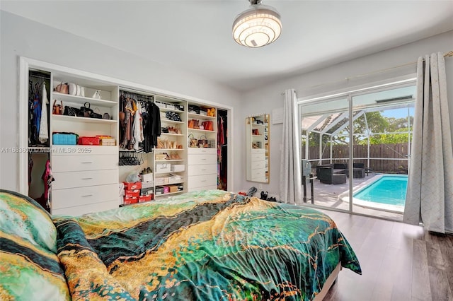 bedroom with hardwood / wood-style flooring, access to outside, and a closet