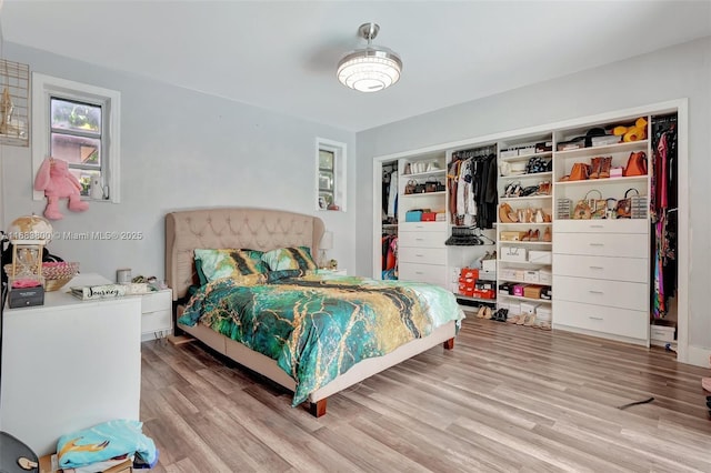 bedroom featuring light hardwood / wood-style flooring and a closet