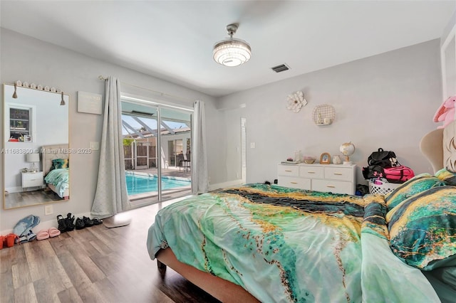 bedroom with access to outside and wood-type flooring