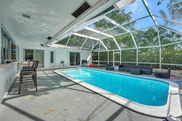 view of swimming pool featuring a patio area, a lanai, and an outdoor hangout area