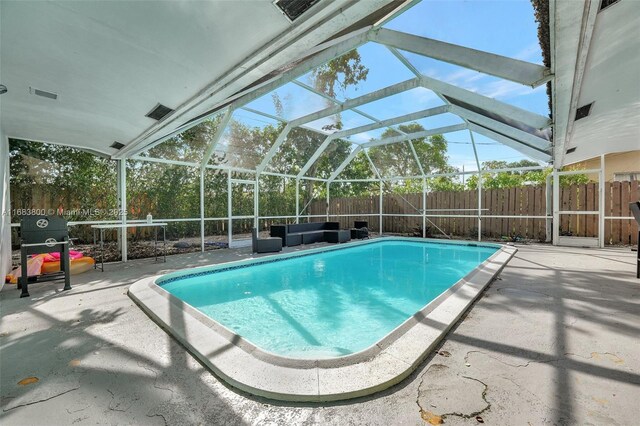 view of pool with a lanai and a patio