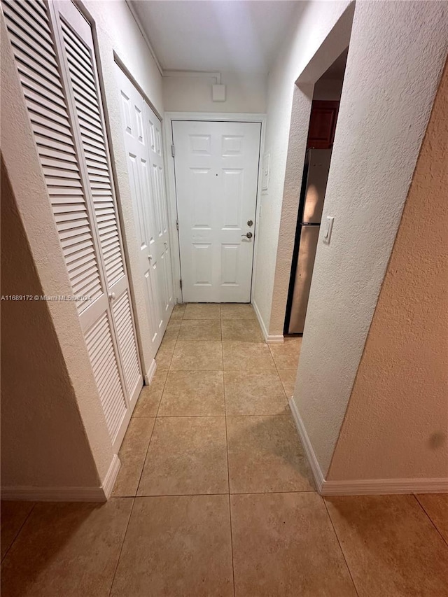 corridor with light tile patterned floors