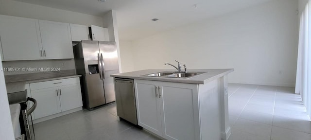 kitchen featuring white cabinetry, appliances with stainless steel finishes, sink, and an island with sink