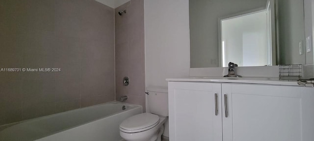 full bathroom with toilet, vanity, and tiled shower / bath