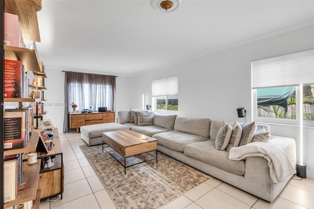 living room featuring ornamental molding and light tile patterned flooring