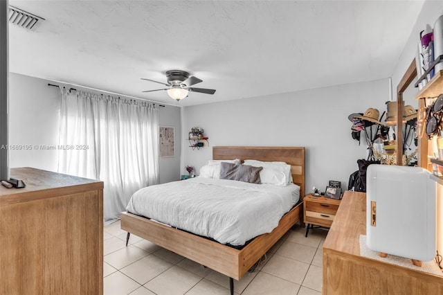 tiled bedroom with ceiling fan