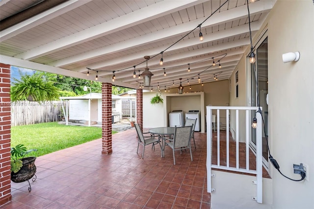 view of patio / terrace with a storage shed and independent washer and dryer